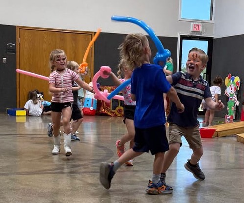 Balloon twisting artist entertaining kids at a Texas event