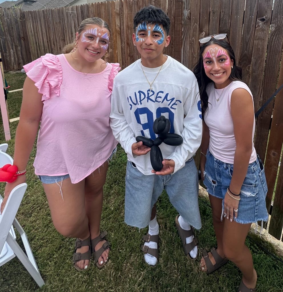 Three kids with matching butterfly face painting at a Texas party