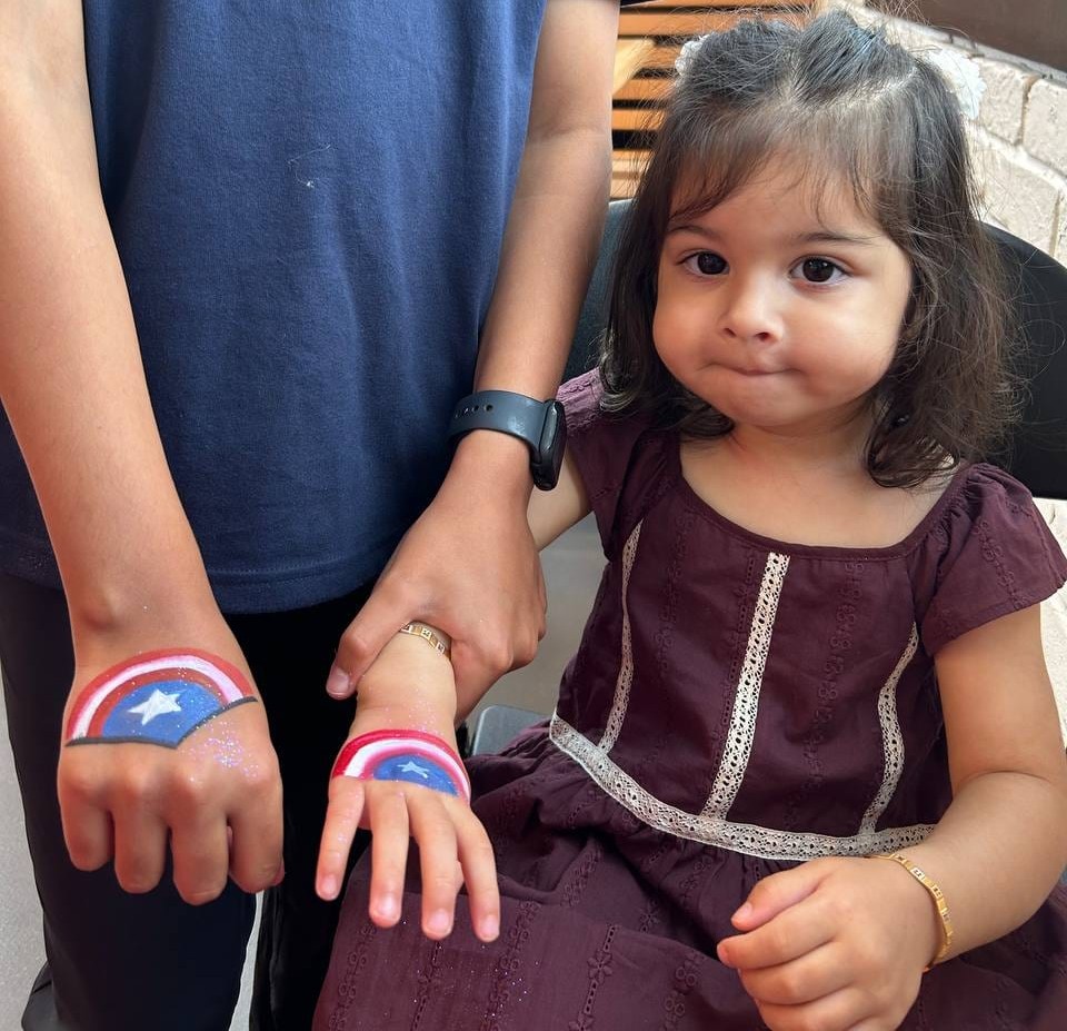Captain America shield arm painting at a Texas party