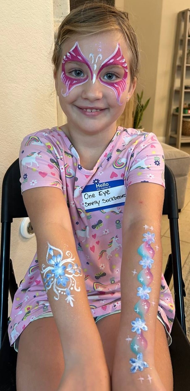 Coordinated face and arm painting at a Texas kids party