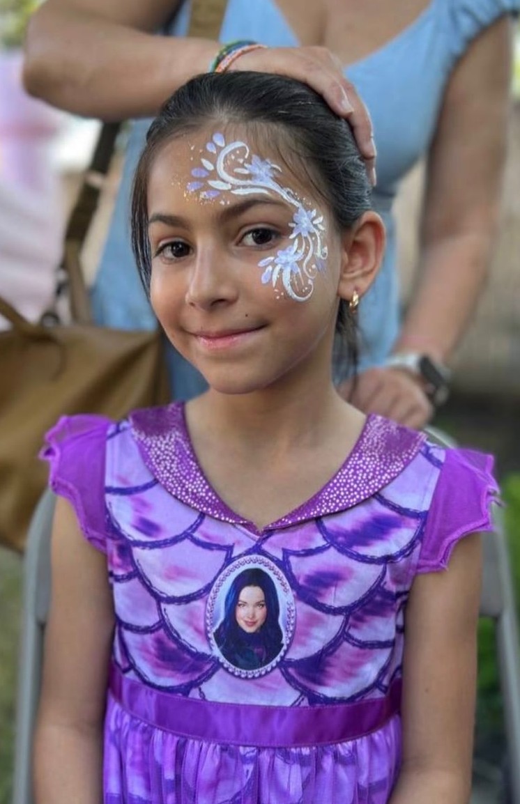 Floral face painting design at a Texas kids party