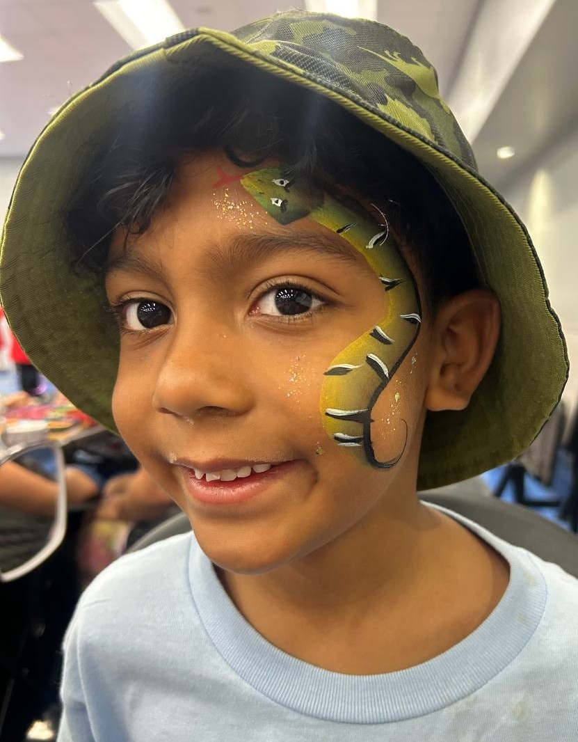 Snake face painting on a child at a Texas party