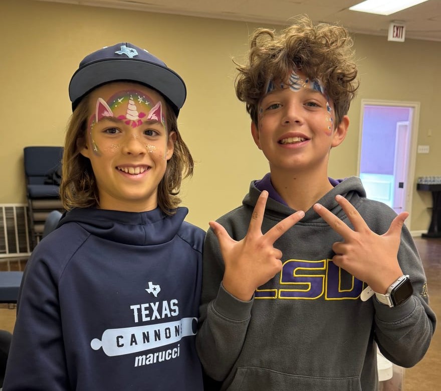 Rainbow unicorn face painting at a Texas kids party