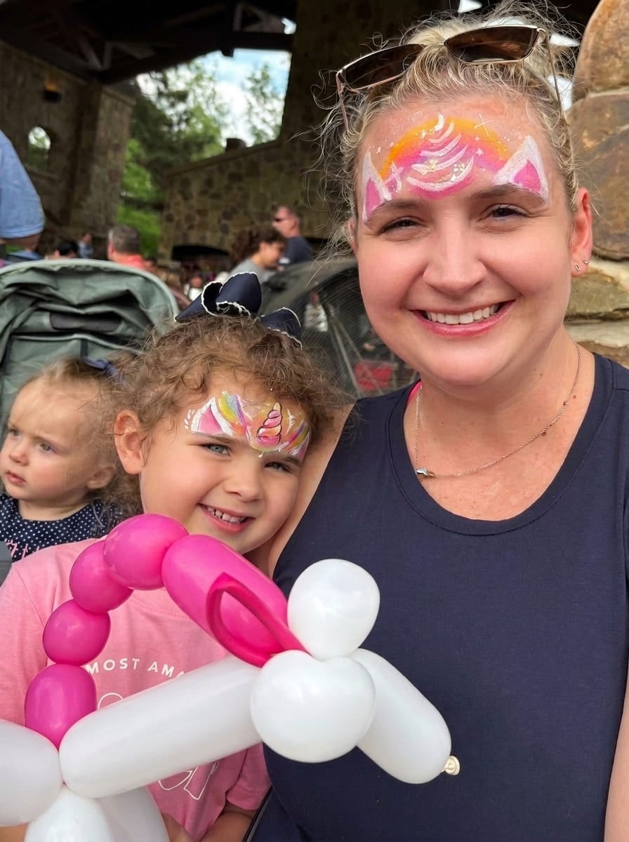 Mom and daughter with matching unicorn face painting at a Texas party